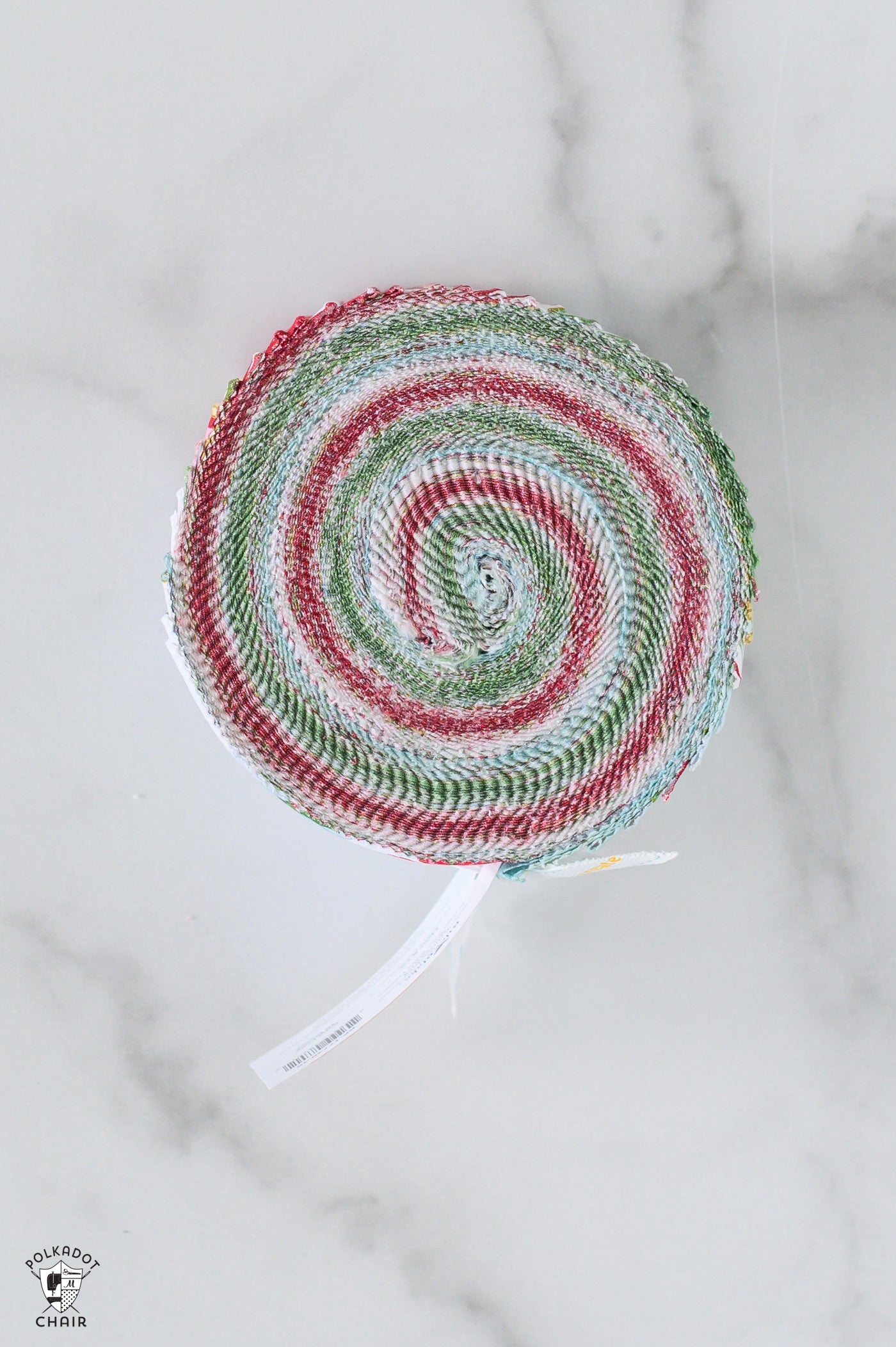 Round woven mat with red and green pattern on a marble surface