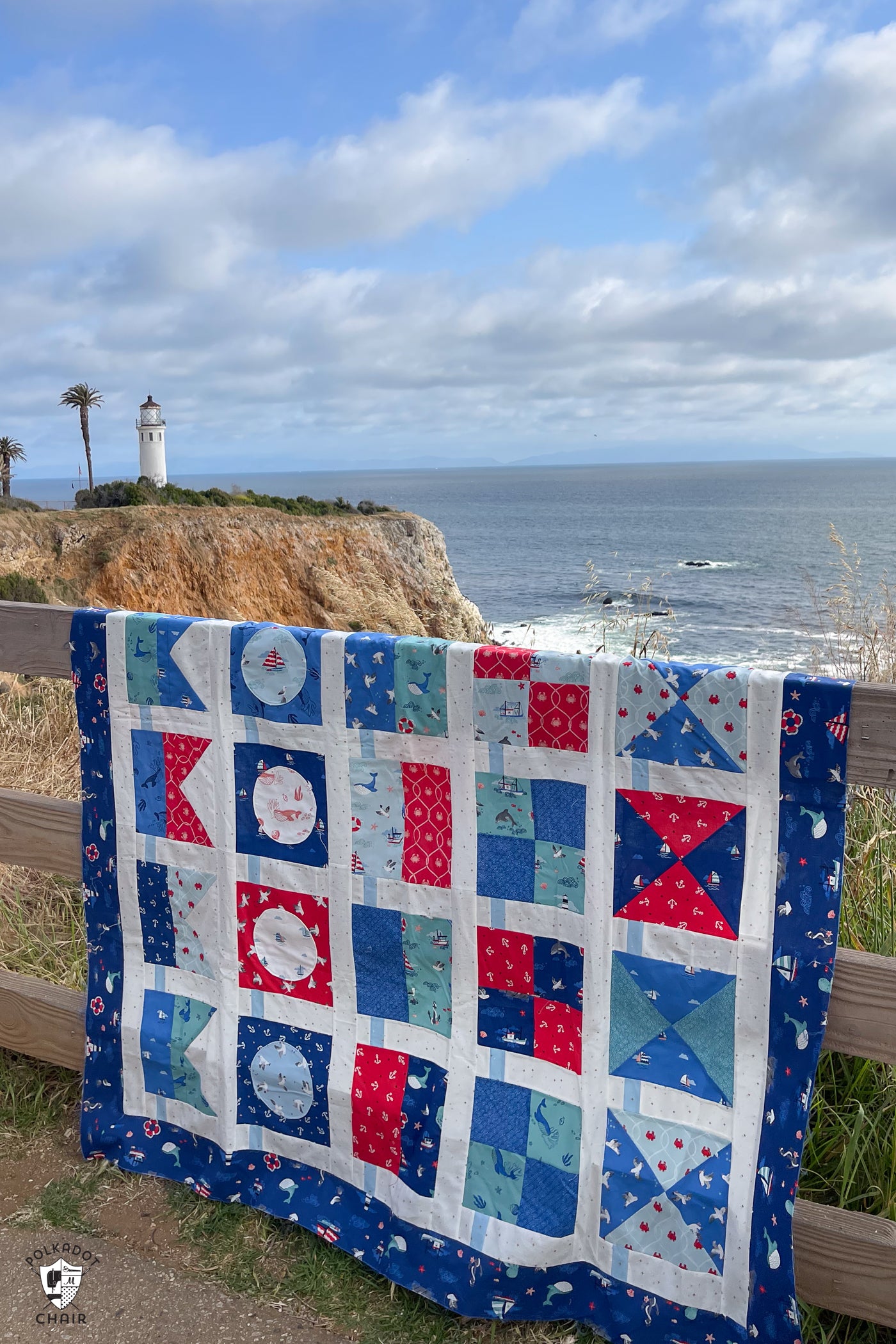 red white and blue nautical quilt out doors in front of light house and ocean