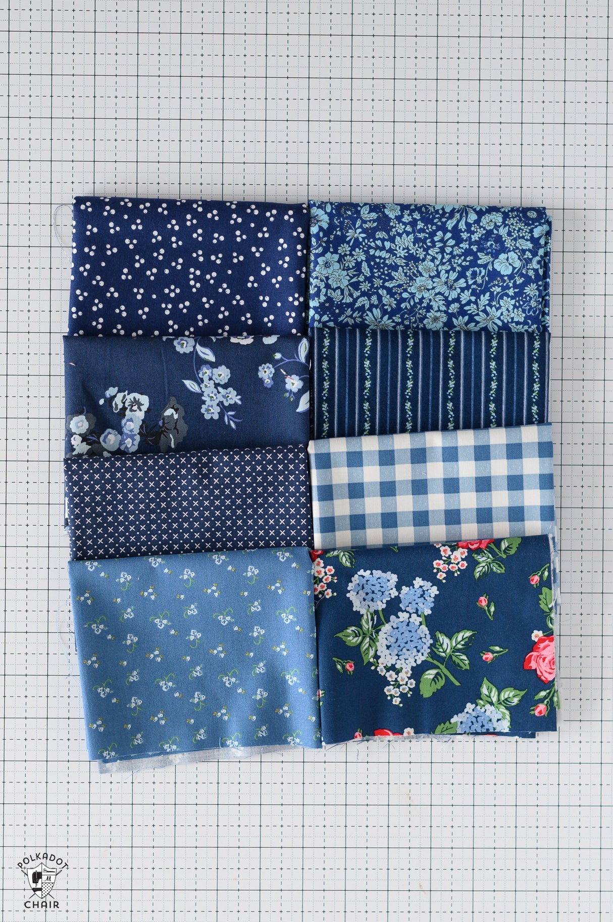Nine patch of blue fabric squares on a grid background