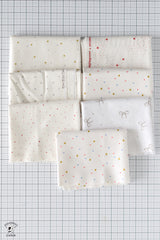 Set of white fabric swatches with patterns on a grid background