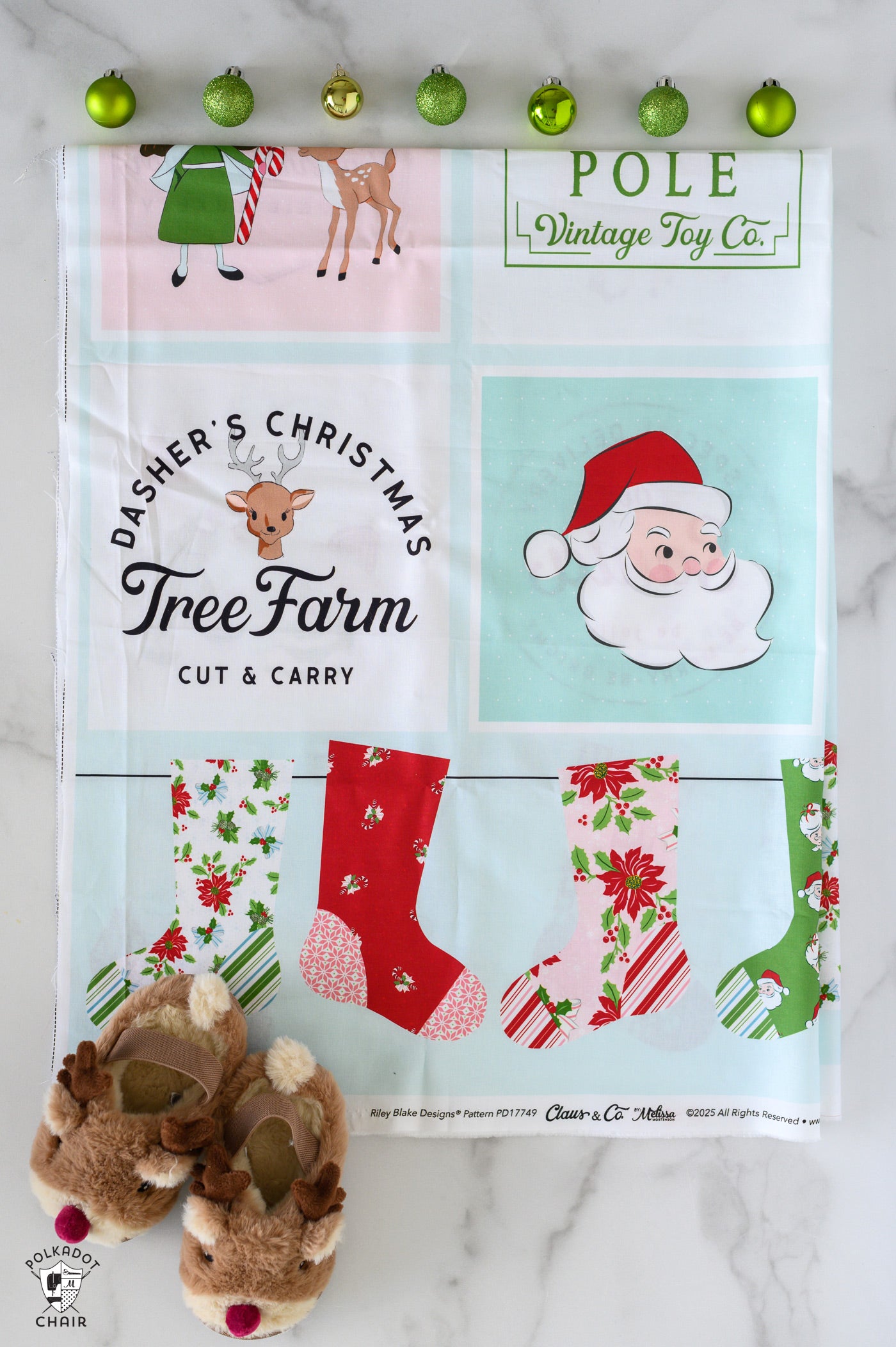 Christmas-themed fabric panel with Santa Claus, reindeer, and stockings on a white background.
