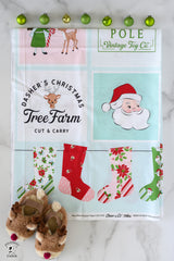 Christmas-themed fabric panel with Santa Claus, reindeer, and stockings on a white background.