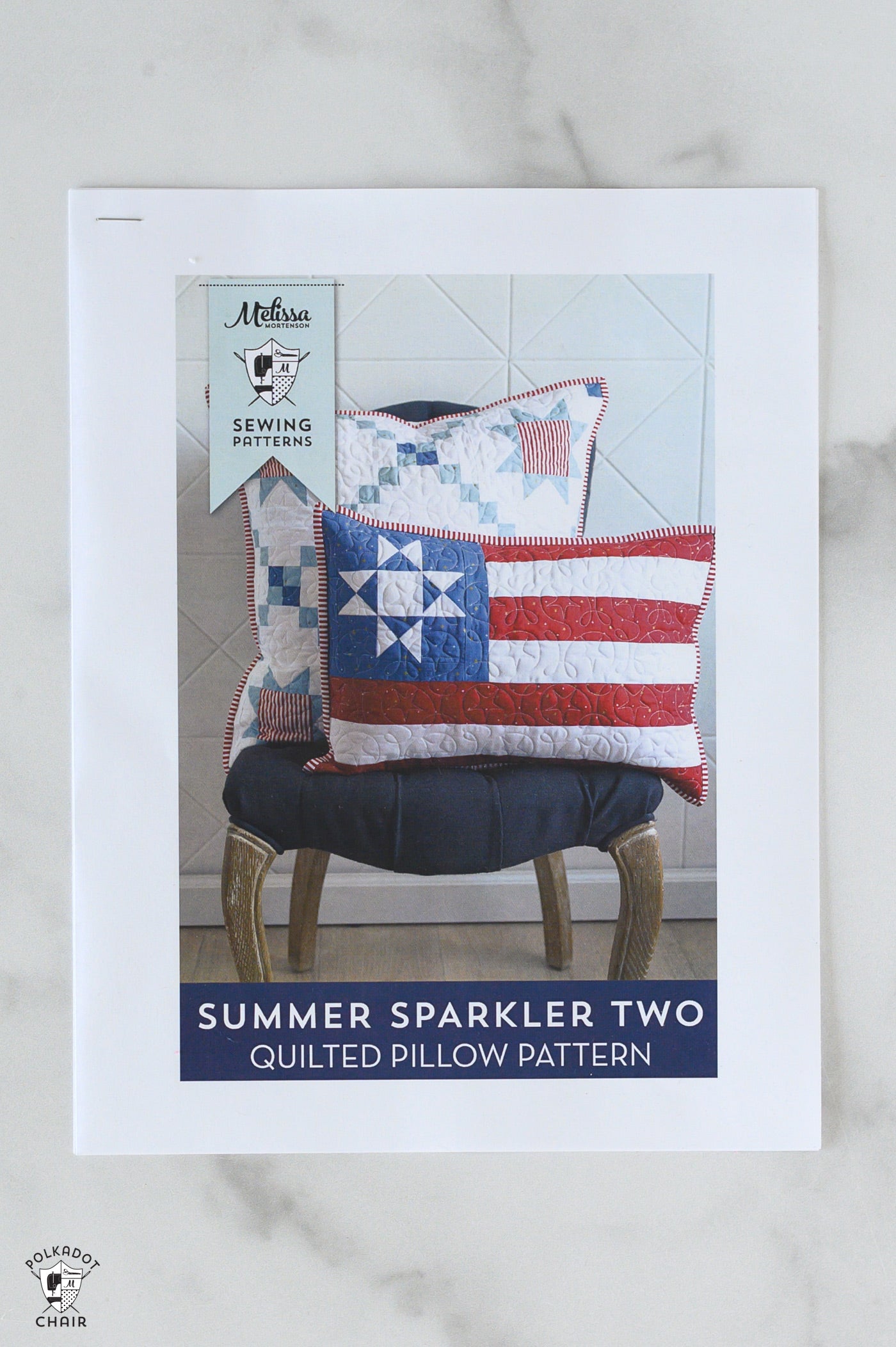Quilted pillow pattern cover with a chair and pillows on a neutral background