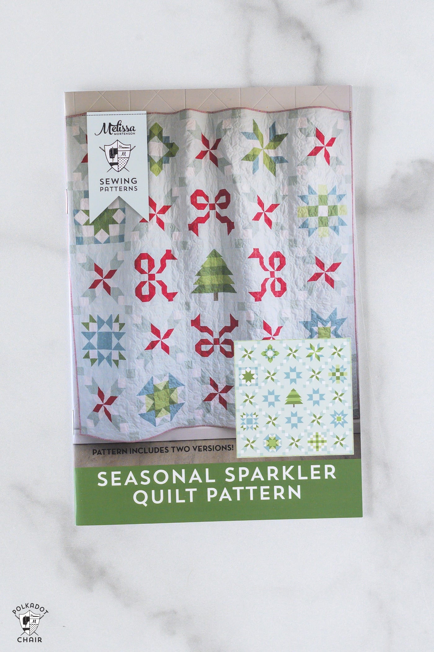 Seasonal Sparkler quilt pattern packaging on a marble surface